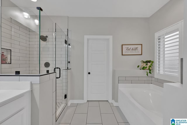 bathroom with tile patterned floors, vanity, and independent shower and bath