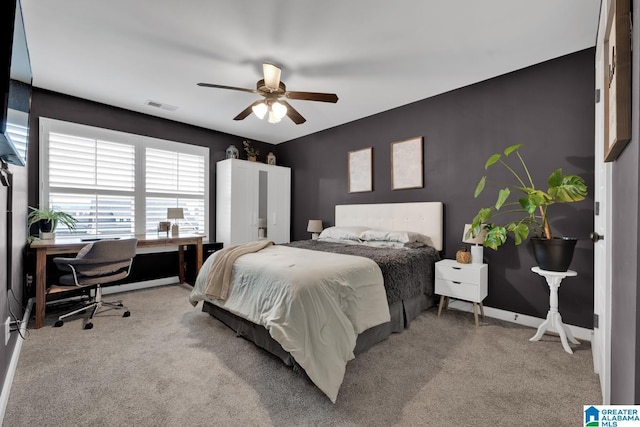 bedroom with ceiling fan and light carpet