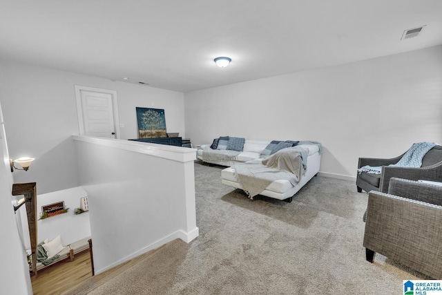 living room with a fireplace and light colored carpet