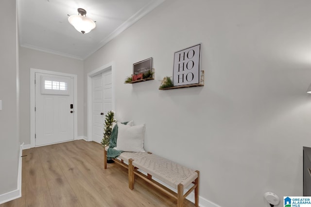 entryway featuring light wood-type flooring and crown molding