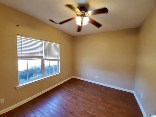 spare room featuring ceiling fan and dark hardwood / wood-style flooring