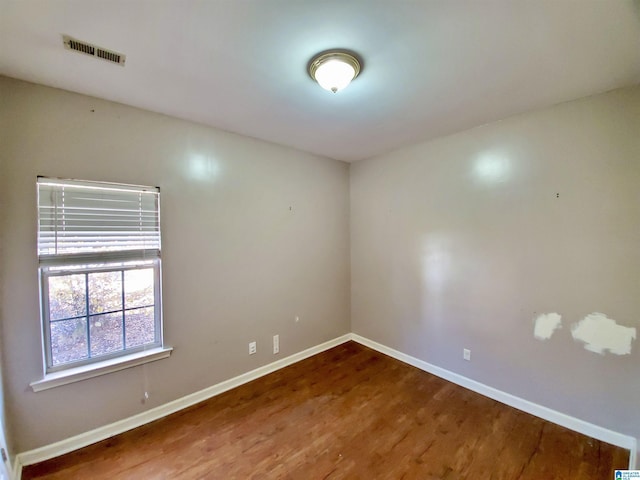 spare room featuring wood-type flooring