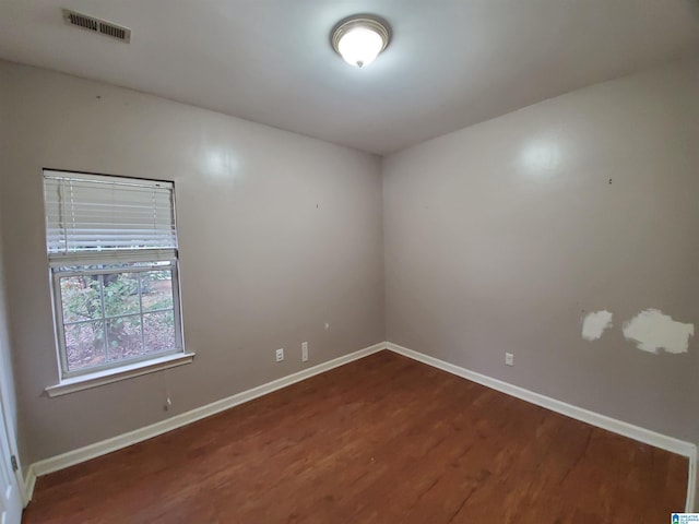 spare room with dark hardwood / wood-style floors