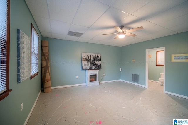 empty room featuring ceiling fan and a drop ceiling