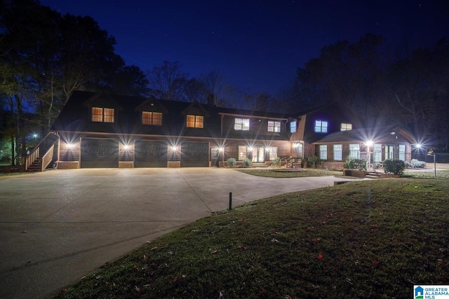 view of front facade featuring a garage and a lawn