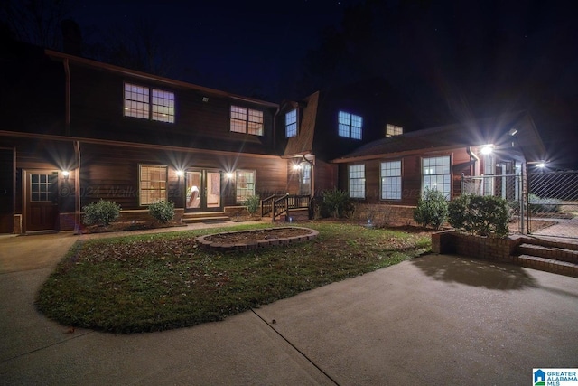 view of back house at twilight