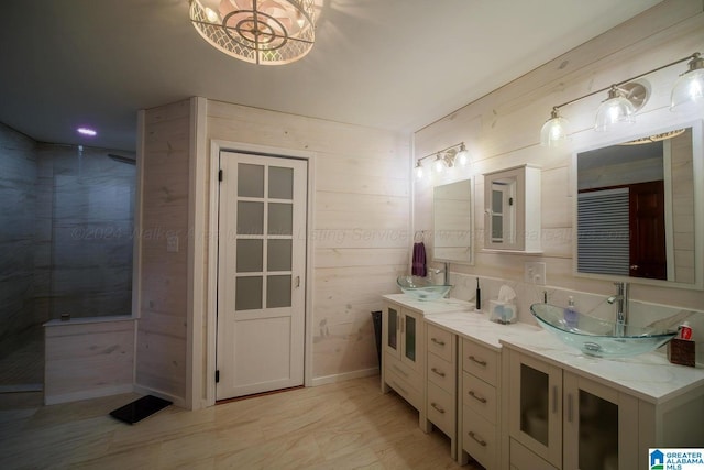 bathroom featuring vanity and wooden walls