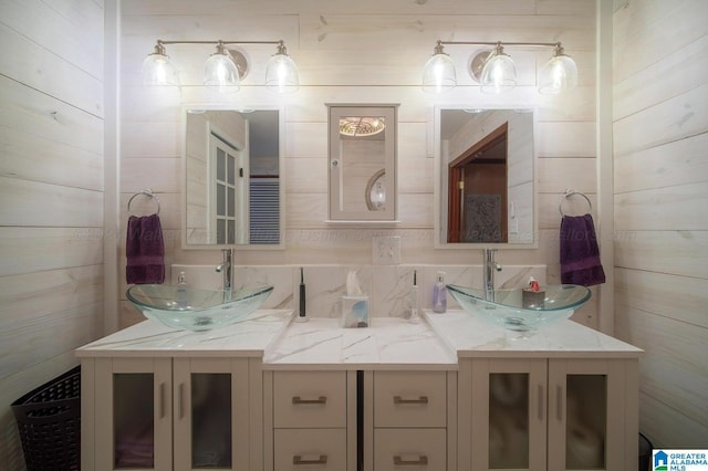 bathroom with vanity and wood walls