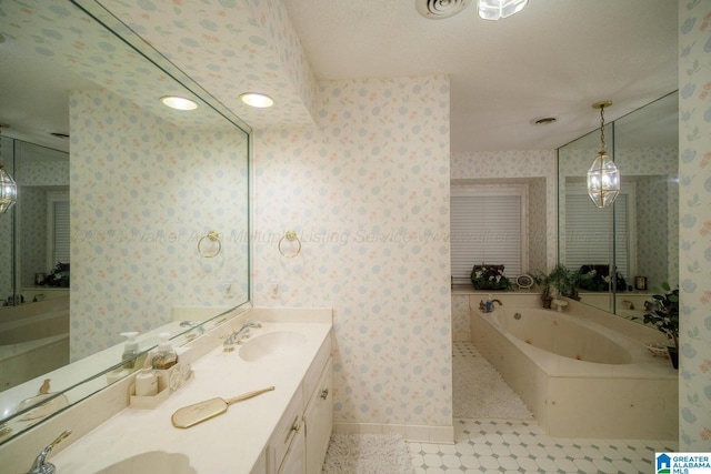 bathroom with tile patterned flooring, a textured ceiling, vanity, and a tub to relax in