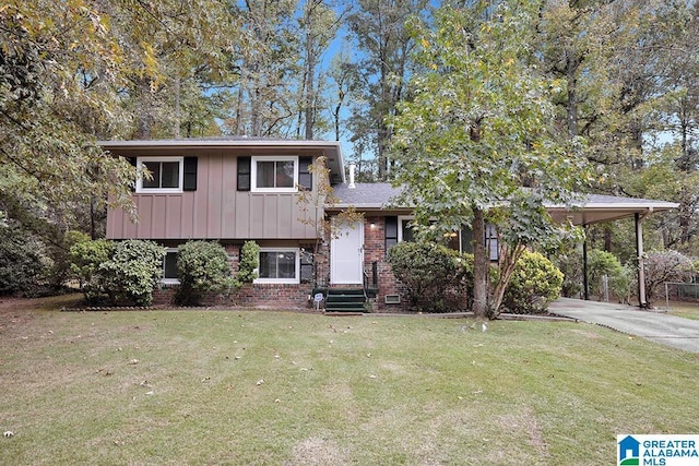 tri-level home with a carport and a front lawn