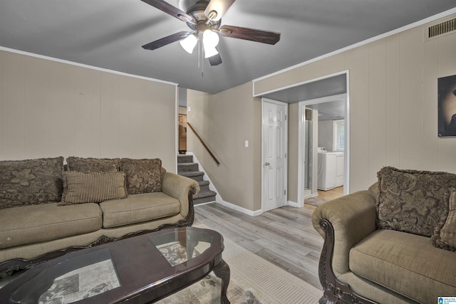 living room with ceiling fan, light hardwood / wood-style floors, washer / dryer, and ornamental molding