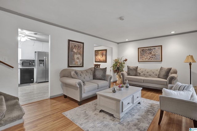 living room with ceiling fan, crown molding, and light hardwood / wood-style floors