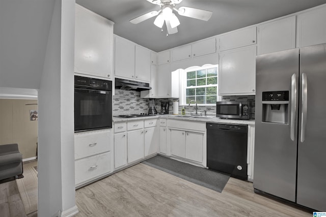 kitchen with black appliances, white cabinets, light wood-type flooring, and sink