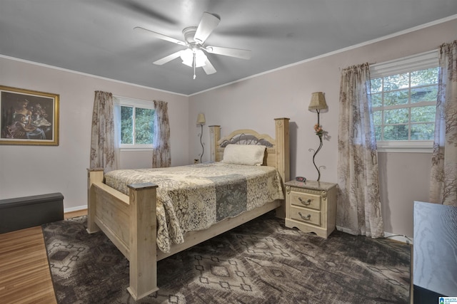 bedroom with ceiling fan and ornamental molding