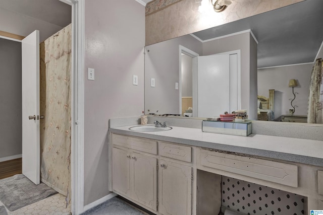 bathroom with crown molding and vanity