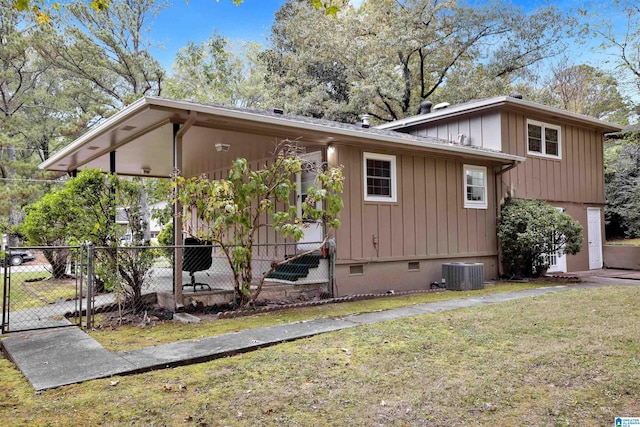 exterior space with central air condition unit and a yard