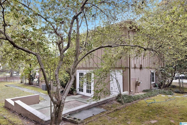 exterior space featuring a lawn and french doors