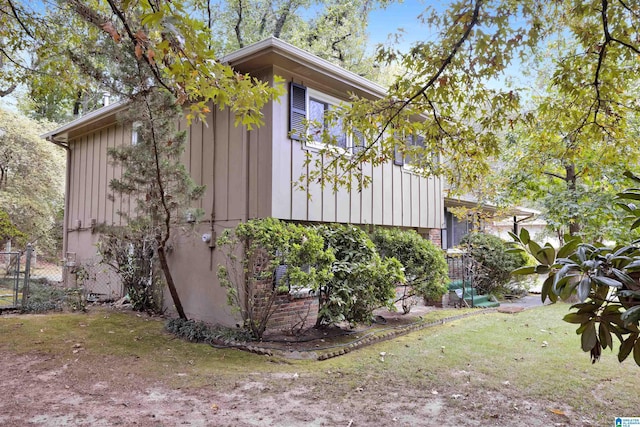 view of side of property with a lawn