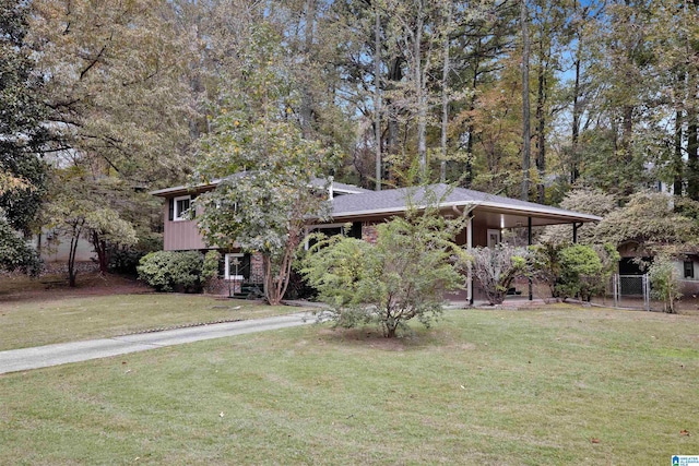 view of front of house with a front yard and a carport