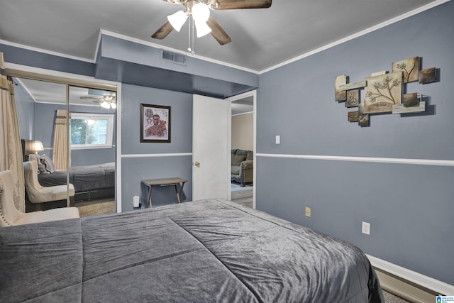 bedroom with ceiling fan, ornamental molding, carpet floors, and a closet