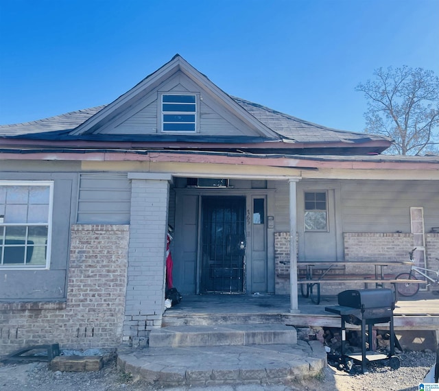 view of exterior entry with a porch