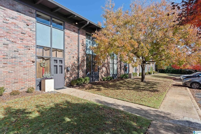 view of property exterior with a lawn