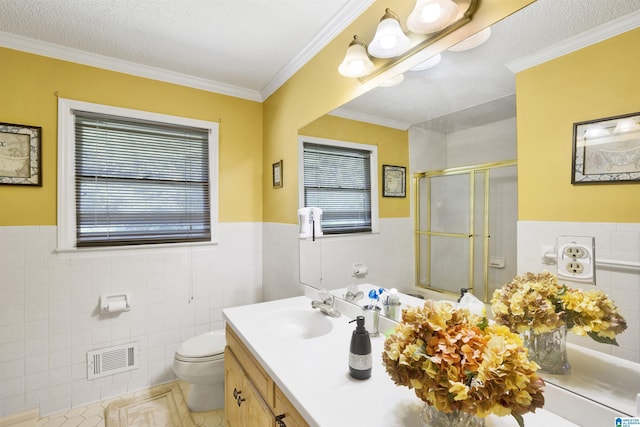 bathroom with tile patterned flooring, crown molding, tile walls, and a healthy amount of sunlight