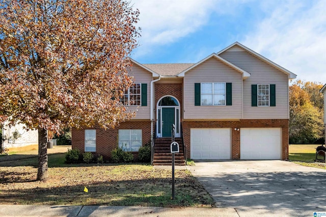 bi-level home featuring a front yard and a garage