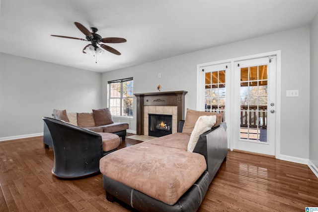 living room featuring a fireplace, hardwood / wood-style flooring, and ceiling fan