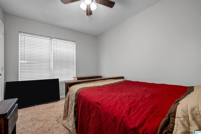 carpeted bedroom featuring ceiling fan and vaulted ceiling