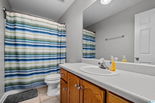 bathroom featuring toilet, vanity, tile patterned floors, and curtained shower