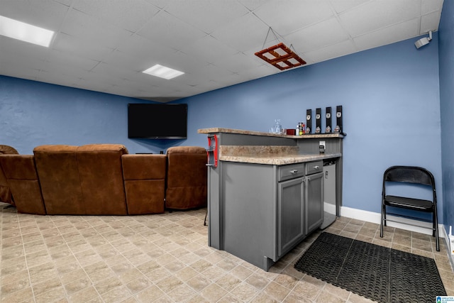 kitchen with gray cabinets and light tile patterned floors