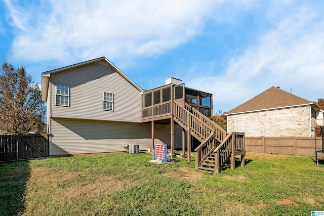 back of property featuring a sunroom and a yard