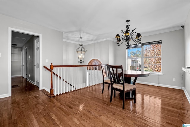 dining space featuring a chandelier, hardwood / wood-style floors, and crown molding