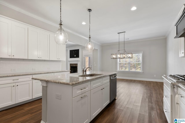 kitchen with white cabinetry, a center island with sink, and decorative light fixtures