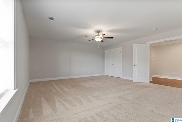 spare room with light carpet and ceiling fan