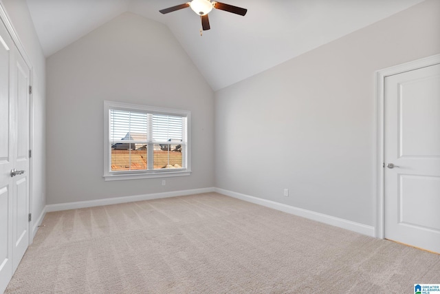 unfurnished bedroom featuring ceiling fan, high vaulted ceiling, and light colored carpet