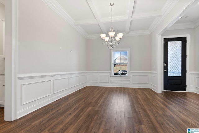 interior space featuring beam ceiling, dark wood-type flooring, coffered ceiling, an inviting chandelier, and crown molding