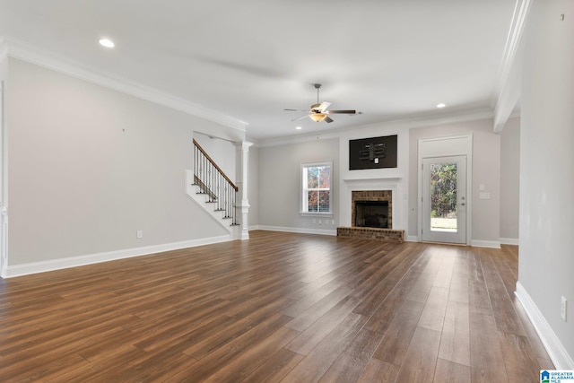 unfurnished living room with ornamental molding, a wealth of natural light, and dark wood-type flooring