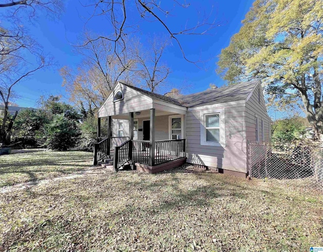 view of front of home featuring covered porch and a front yard