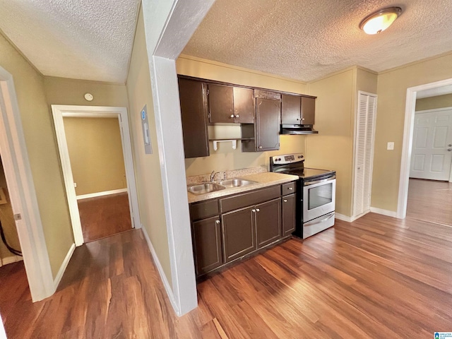 kitchen featuring electric stove, sink, dark brown cabinets, and dark hardwood / wood-style flooring