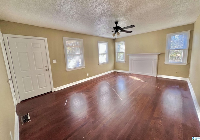 foyer entrance with a textured ceiling, dark hardwood / wood-style flooring, and ceiling fan