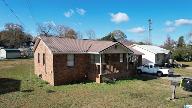 view of front of house with a porch and a front lawn