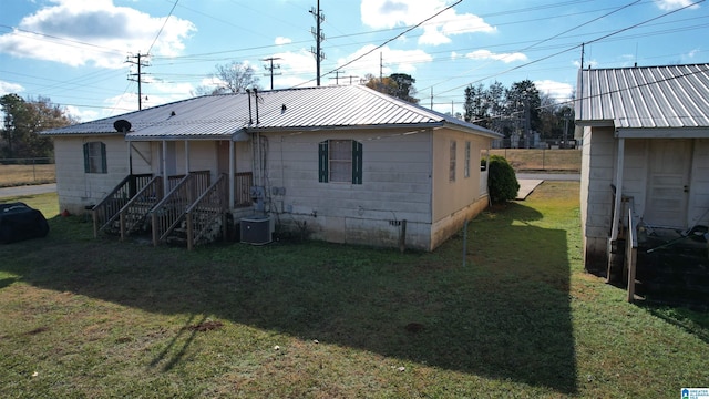 back of house with a yard and cooling unit