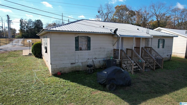 back of property with a lawn