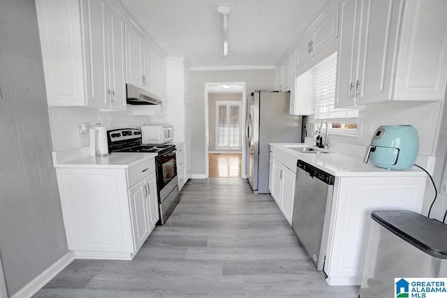 kitchen featuring white cabinets, light hardwood / wood-style floors, sink, and appliances with stainless steel finishes