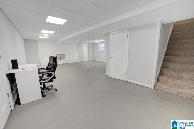 office featuring a drop ceiling and concrete flooring