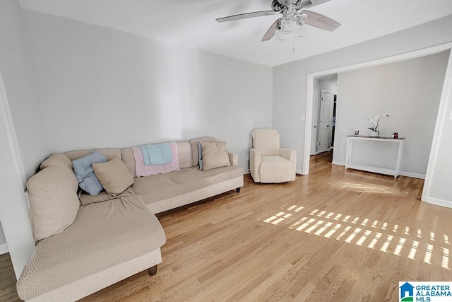 living room featuring light hardwood / wood-style floors and ceiling fan