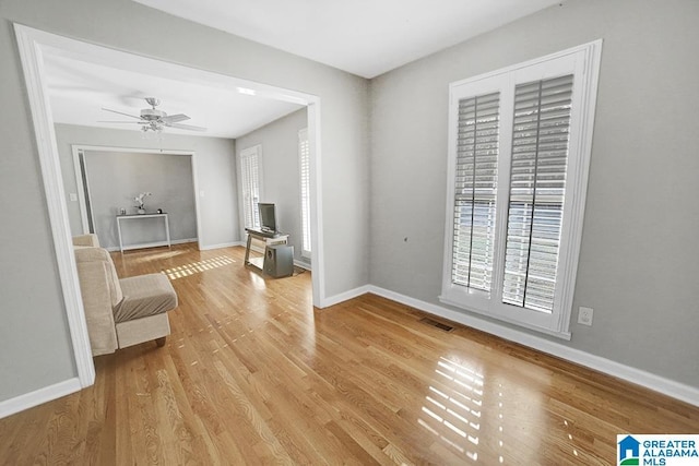 sitting room featuring ceiling fan and light wood-type flooring