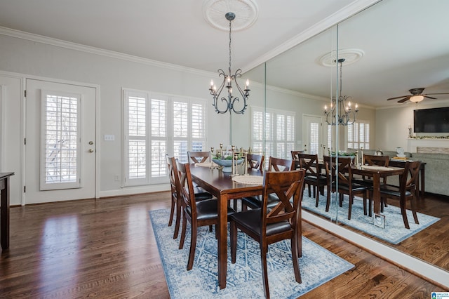 dining space featuring ceiling fan with notable chandelier, crown molding, and dark wood-type flooring